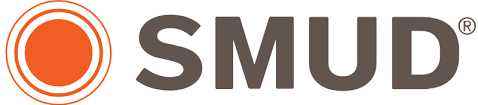 SMUD logo featuring a large orange circle with two thin orange rings around it, next to bold dark gray letters spelling SMUD with a small registered trademark symbol, as seen at the Ohana Walk fundraiser benefiting ACC Senior Services.