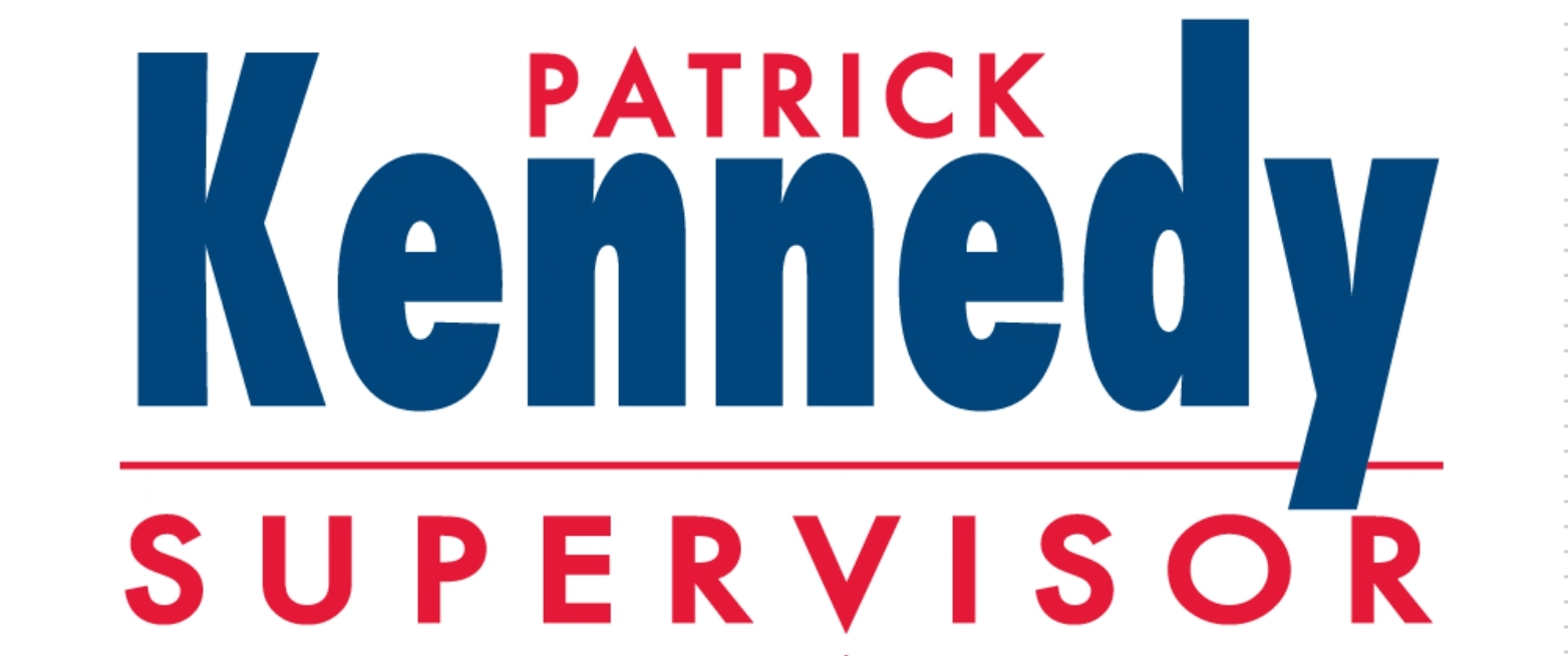 Campaign sign reads: Patrick Kennedy Supervisor with Kennedy in large blue letters, Patrick and Supervisor in smaller red letters above and below, separated by a red line. The sign is featured at the Ohana Walk fundraiser supporting ACC Senior Services.
